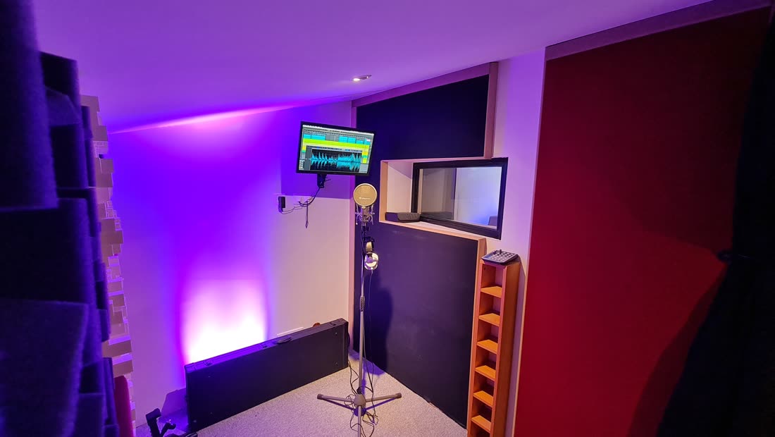 The recording booth and its window onto the control room.