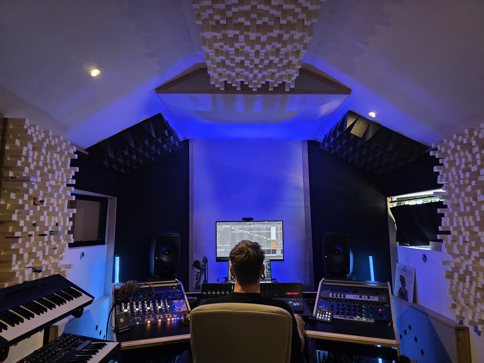 A wide view of the control room, treated ceiling and central listening position.