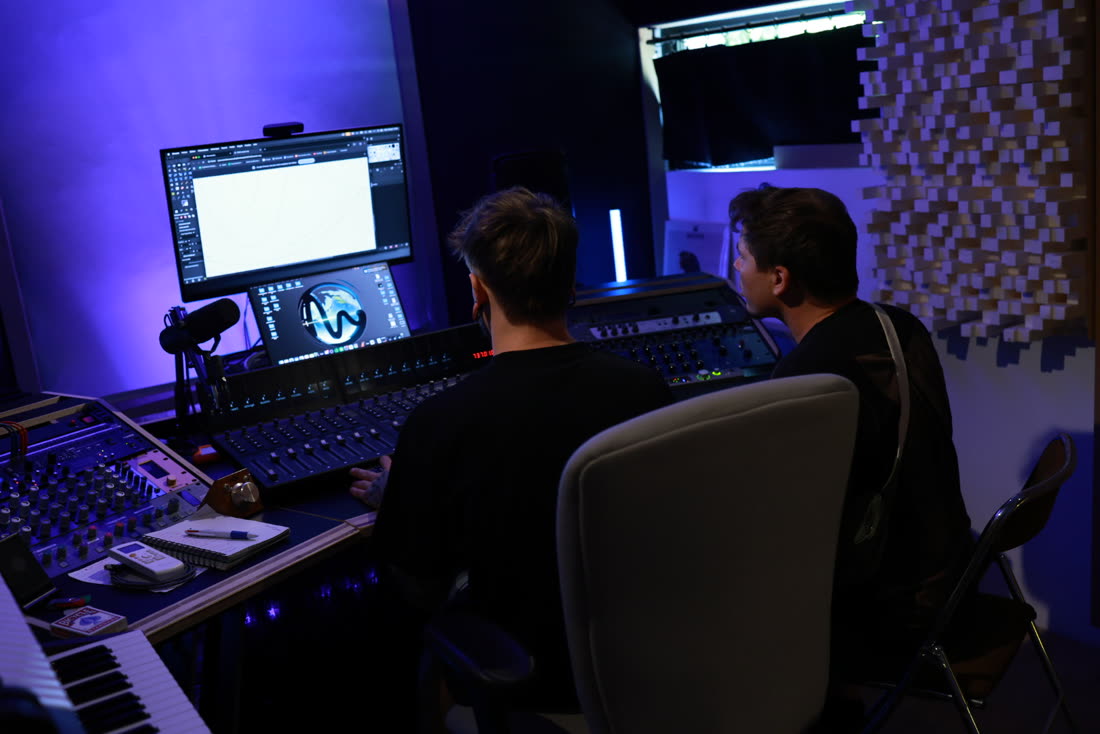 Two people working together at the desk.